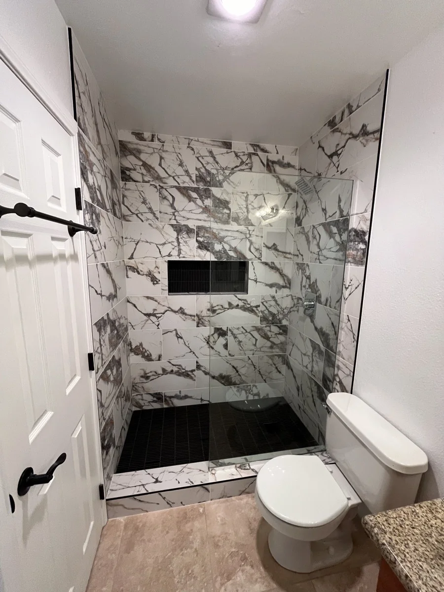 Finished bathroom with tiled walk-in shower
